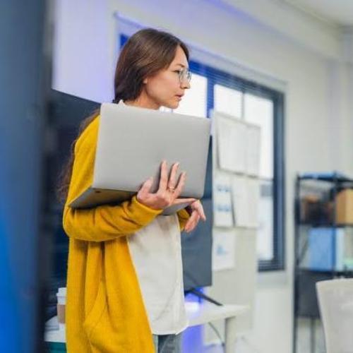 Person holding a computer laptop