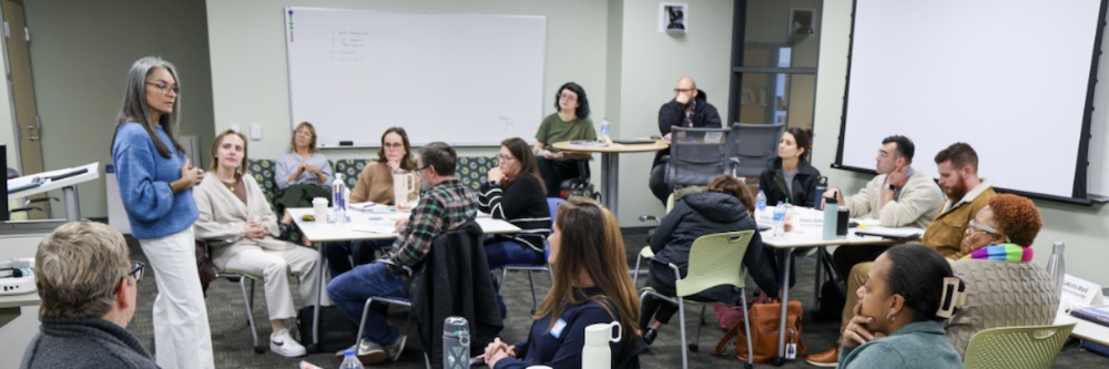Students in the classroom, listening to a professor