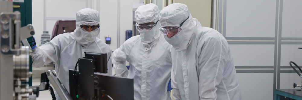People in a clean room looking intently
