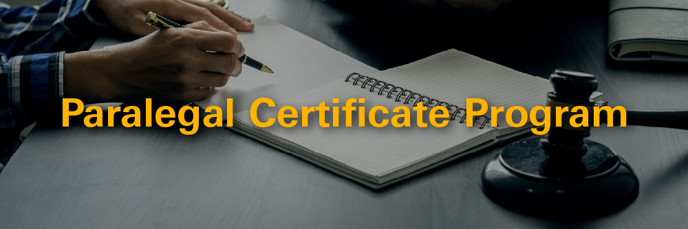 Picture of someone signing a document with the words paralegal certificate program superimposed over top of it