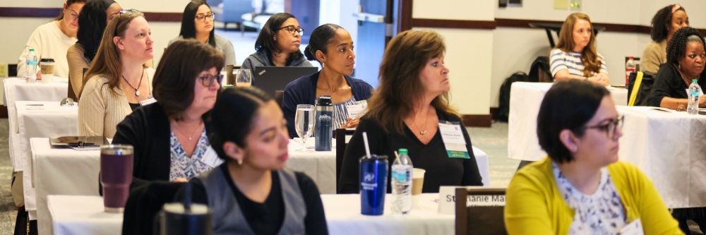 Photo of people sittig at tables at VMCA Institutes and Academy
