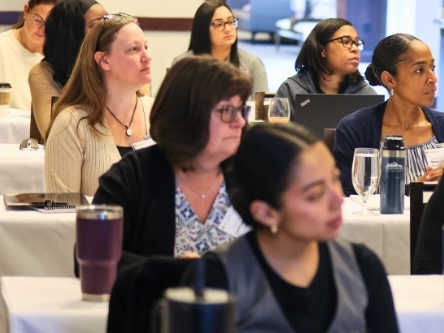 Photo of people sittig at tables at VMCA Institutes and Academy