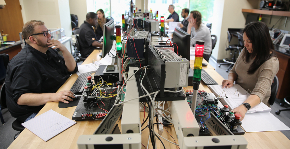 Photo of students in a lab learning automation and controls.